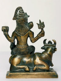 Brass Lord Shiva statue on Nandi, side view showing Nandi horns and Shiva arms
