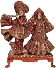 17-inch brass Radha-Krishna statue in ornate red patina, dancing poses