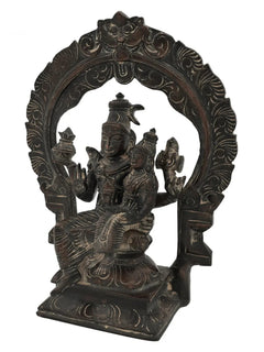 Brass Shiva and Parvati idol with halo-style kirtimukha arch, seated on pedestal