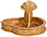 Brass Shiva linga statue in round tray with detailed snake coil and rim motifs.