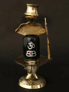 Black stone Shiva linga with Om markings, brass trishul and patra base