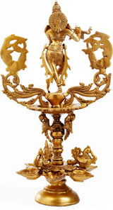 Brass Krishna devotional lamp, standing flute figure on multi-bowl pedestal