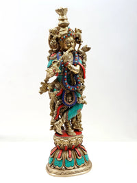 Brass Krishna flute statue with ornate crown and colorful bead inlay, full height