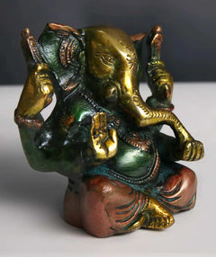 3-inch brass Ganpati statue, seated pose, gold accents on crown and arms