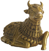Natural brass Nandi statue close-up, detailed face and shoulder adornments, seated