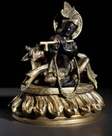 Brass seated Murli Manohar Krishna with ornate headdress, flute and cow, 8-inch