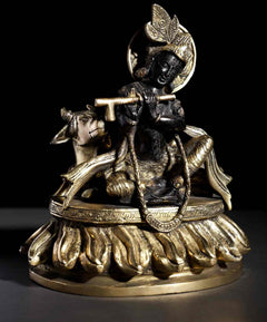 Brass seated Murli Manohar Krishna with ornate headdress, flute and cow, 8-inch