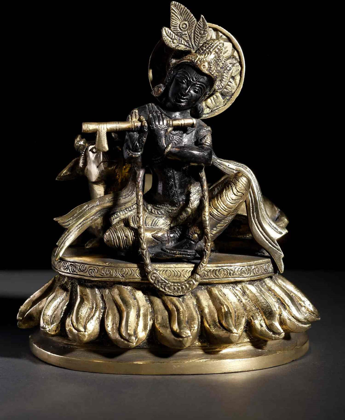 Brass seated Krishna statue with flute and cow figure, 8-inch