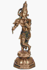 Brass Krishna statue playing flute with detailed crown and colorful accents, full view