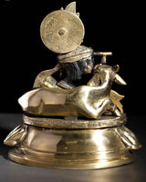 Brass statue rear of seated Krishna with cow figure and flute, 8-inch
