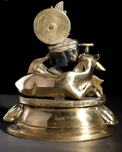 Brass statue rear of seated Krishna with cow figure and flute, 8-inch