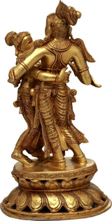 Brass Radha-Krishna dancing idol, side view with ornate legs and pedestal base