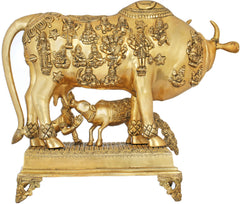 Brass cow sculpture detail view, ornate body carvings and calf figure, on base