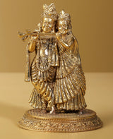 Gold brass Radha Krishna statue with flute, ornate crowns and jewelry, 5 inch
