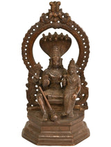 Handmade brass statue of Lord Vishnu with Goddess Lakshmi, seated with ornate halo