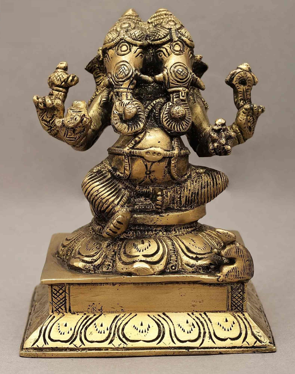 Brass two-headed Ganesha statue, seated with four arms, 5 inches