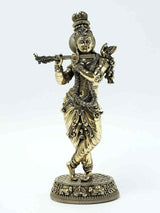 Brass Lord Krishna flute statue with ornate jewelry and dancing pose on pedestal