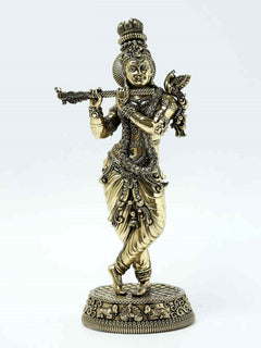 Brass Lord Krishna flute statue with ornate jewelry and dancing pose on pedestal