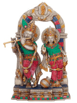 Radha and Krishna brass figurines with detailed crowns, garlands, and colorful inlay