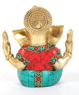 Seated Ganapati brass idol back view with spiral halo; red and turquoise inlay