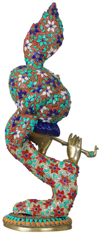 Krishna brass flute sculpture with ornate mosaic robe and raised hand, side view