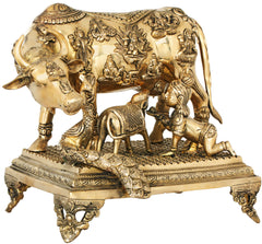 Brass cow sculpture on carved pedestal, front view with horn and detailed figures