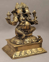 Brass two-headed Ganesha statue on base, ornate detailing, seated posture