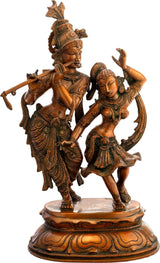 Brass Radha-Krishna dancing statue, raised hands, detailed jewelry on circular base