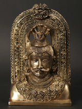 Brass Lord Shiva head idol with kirtimukha face, ornate arched frame, 8-inch statue