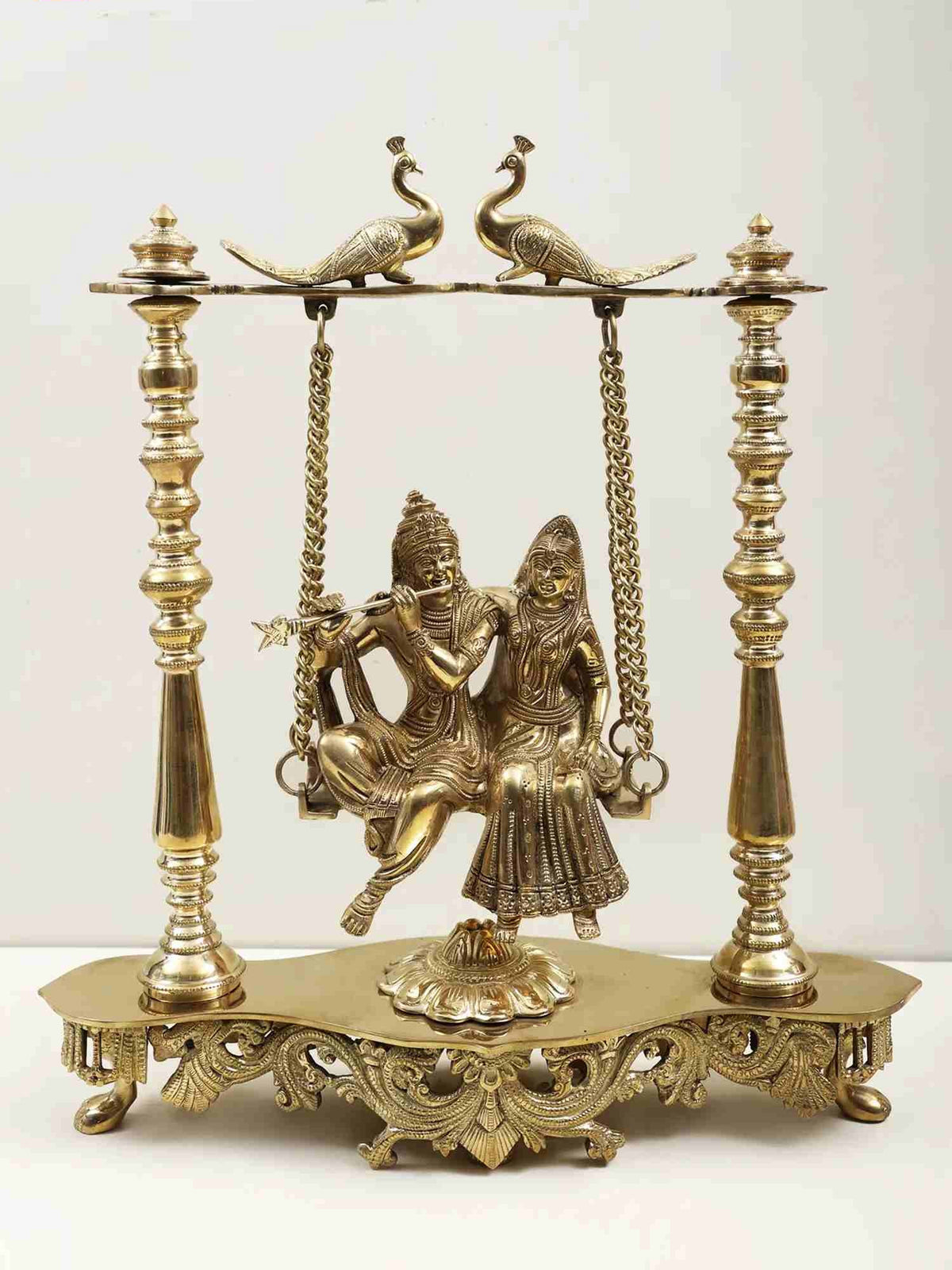 Handmade brass Radha-Krishna swing statue with peacocks, 15-inch base