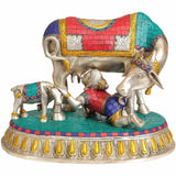 Handmade brass baby Krishna statue drinking cow’s milk, with decorated cow figures