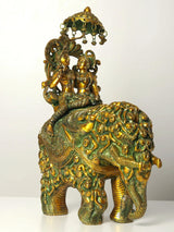 Radha and Krishna brass statue riding an elephant, ornate greenish-gold details and canopy