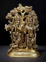 Brass Radha and Krishna statue under ornate tree, standing together, 13-inch