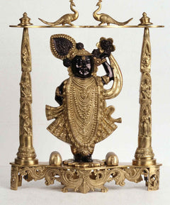 Brass deity statue with dark-faced figure, ornate pillars, 18-inch height