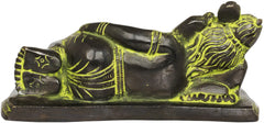 Side view of reclining Ganesha brass statue with black finish and green-gold highlights