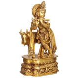 Brass Krishna sculpture playing flute with ornate pedestal base, 19 inches