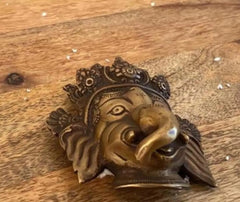 Handmade brass wall mask head close-up of Lord Ganesha with ornate detailing