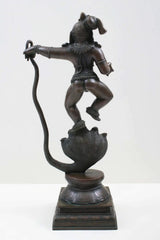 Antique brass Lord Krishna statue defeating Kaliya, side view on cobra base