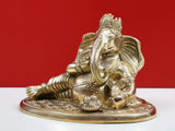 Brass Ganesha idol head and trunk, holding modak, seated on ornate base
