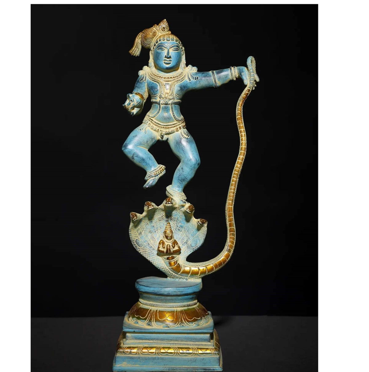 Blue and gold brass Krishna statue, standing atop multi-hood serpent head