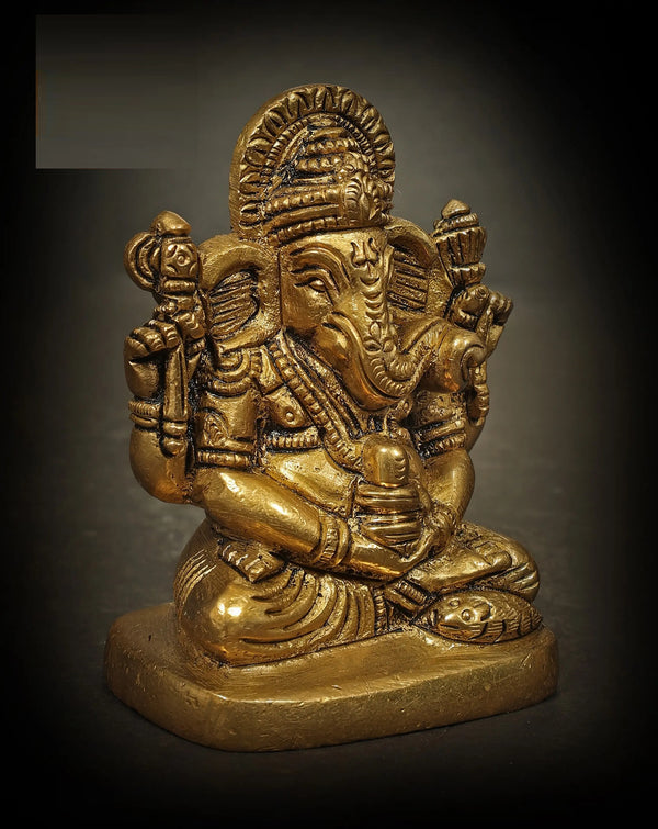 Handmade brass sculpture of a small Ganesha in Shiva Sadhana holding a Shiva Linga 2 Inches