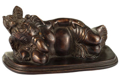 Antique brass Ganesha relaxing statue, raised trunk and seated pose on pedestal