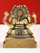 Small brass Ganesha statue, sunburst halo back view, raised arms on pedestal base