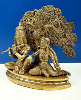 Brass Krishna playing flute beside Radha, detailed ornaments and leafed arch