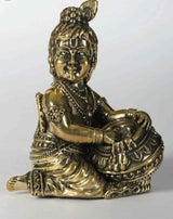 Small brass Krishna statue sitting, holding butter pot, detailed jewelry