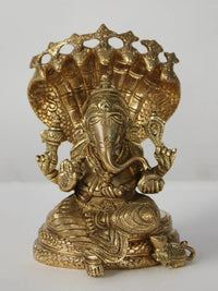 Brass Ganesha seated on Sheshnag with ornate crown and trunk details
