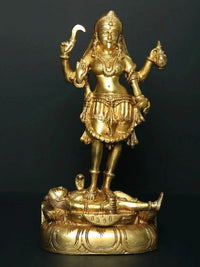 Brass goddess Kali statue standing atop reclining Shiva, ornate base detail