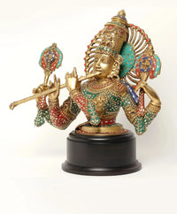 Krishna brass bust on black base, green and red inlay with flute details