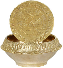 Brass small puja diya with ornate circular lid and raised outer rim bowl
