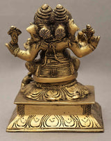 Back view brass two-headed Ganesha statue, raised arms and decorative base